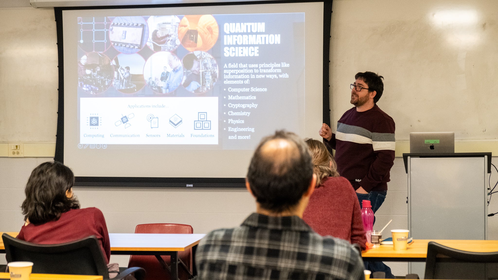 A person giving a presentation to a room full of people. 