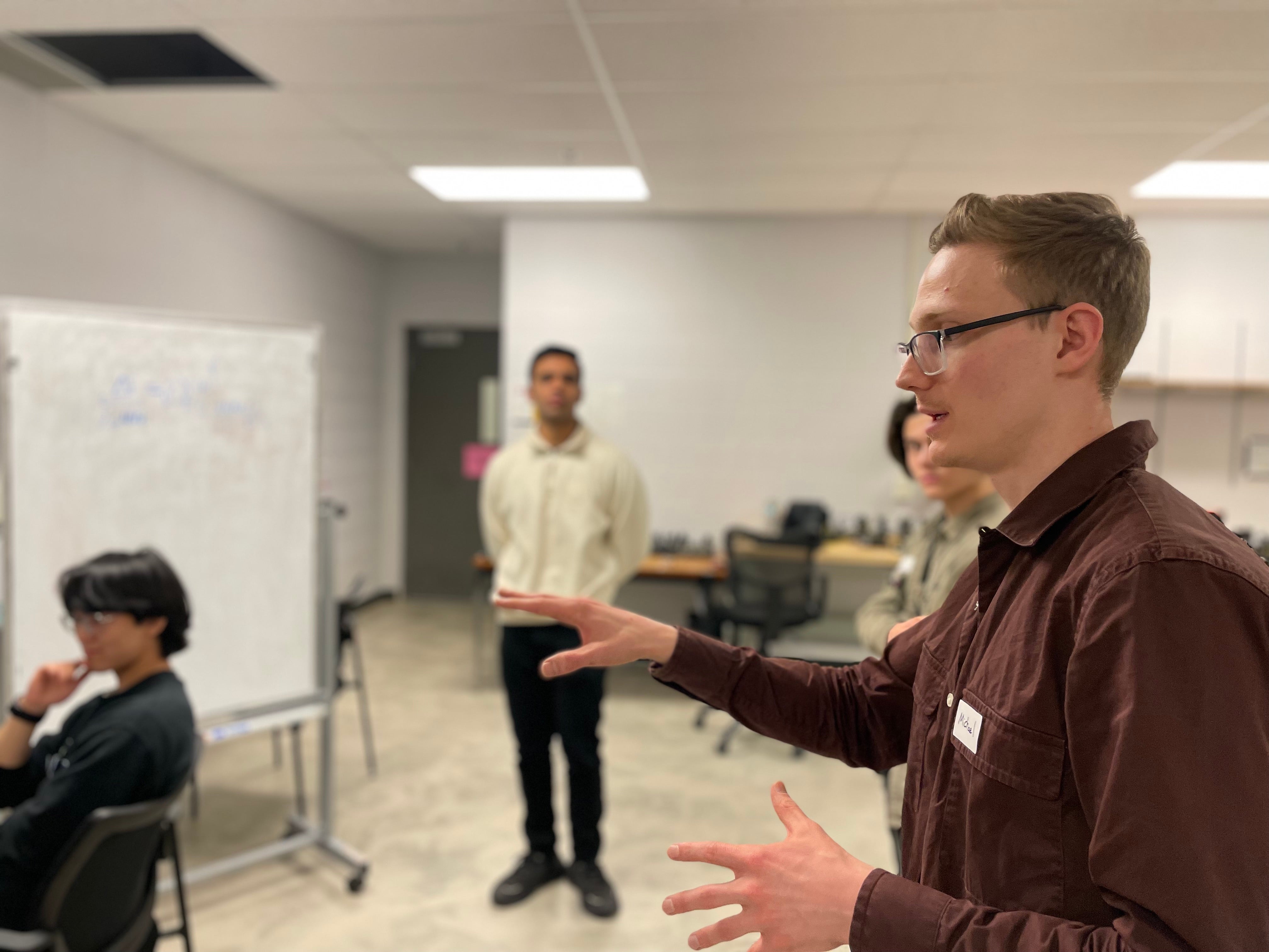 A person explaining to a group of people. 