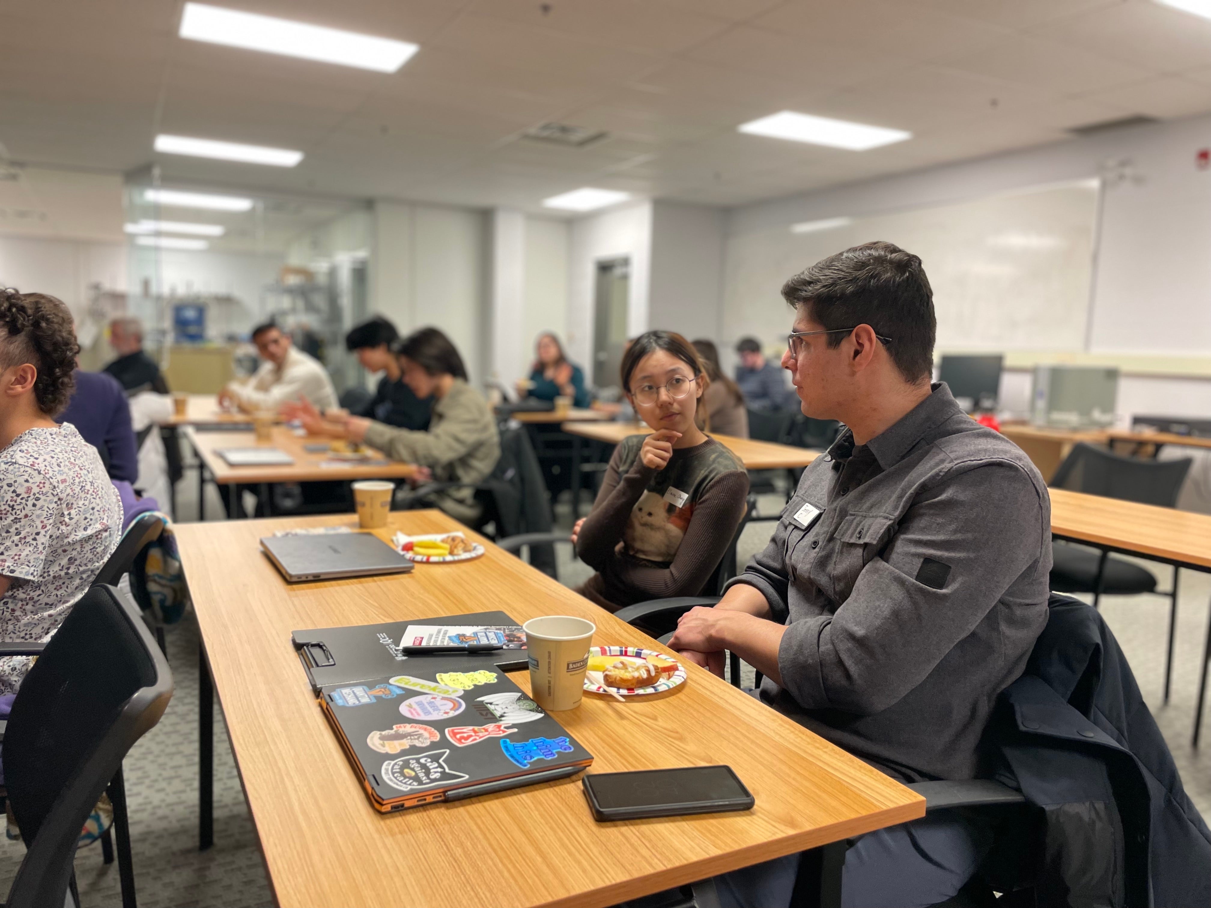 Two people having a discussion at a table. 