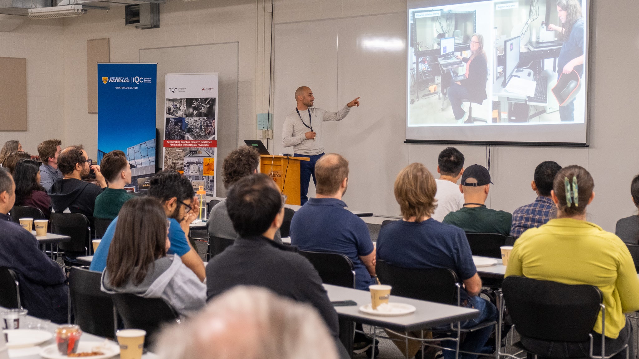 Taso Alkiviades in front of a projector screen