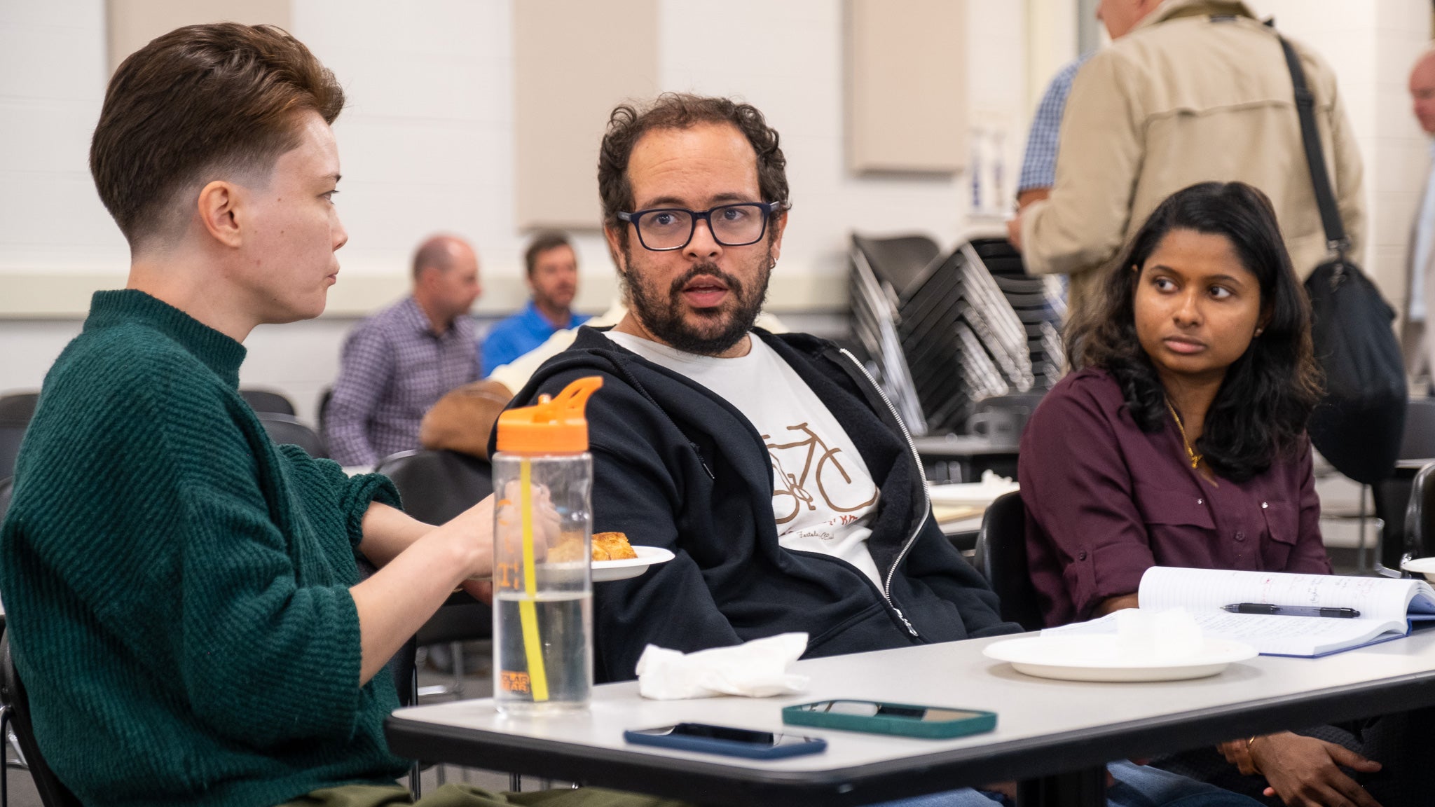 Three people in a discussion/