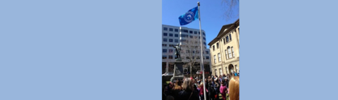 Scottish flag flown in Halifax above a crowd.