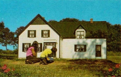 Green Gables doll house with two children in front peering in the windows