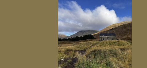 Stone cottage on grassy hill