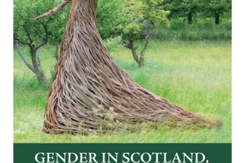 Statue of woman out of branches in an orchard