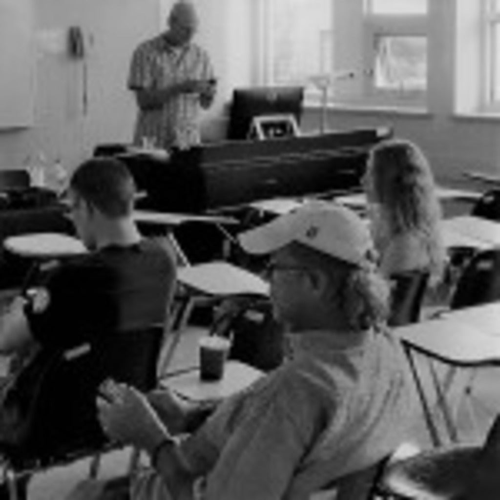 Instructor and students in a classroom taken from the back, black and white