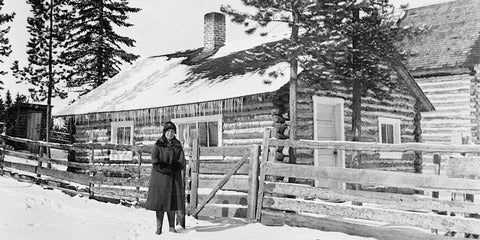 Woman and homestead in snow