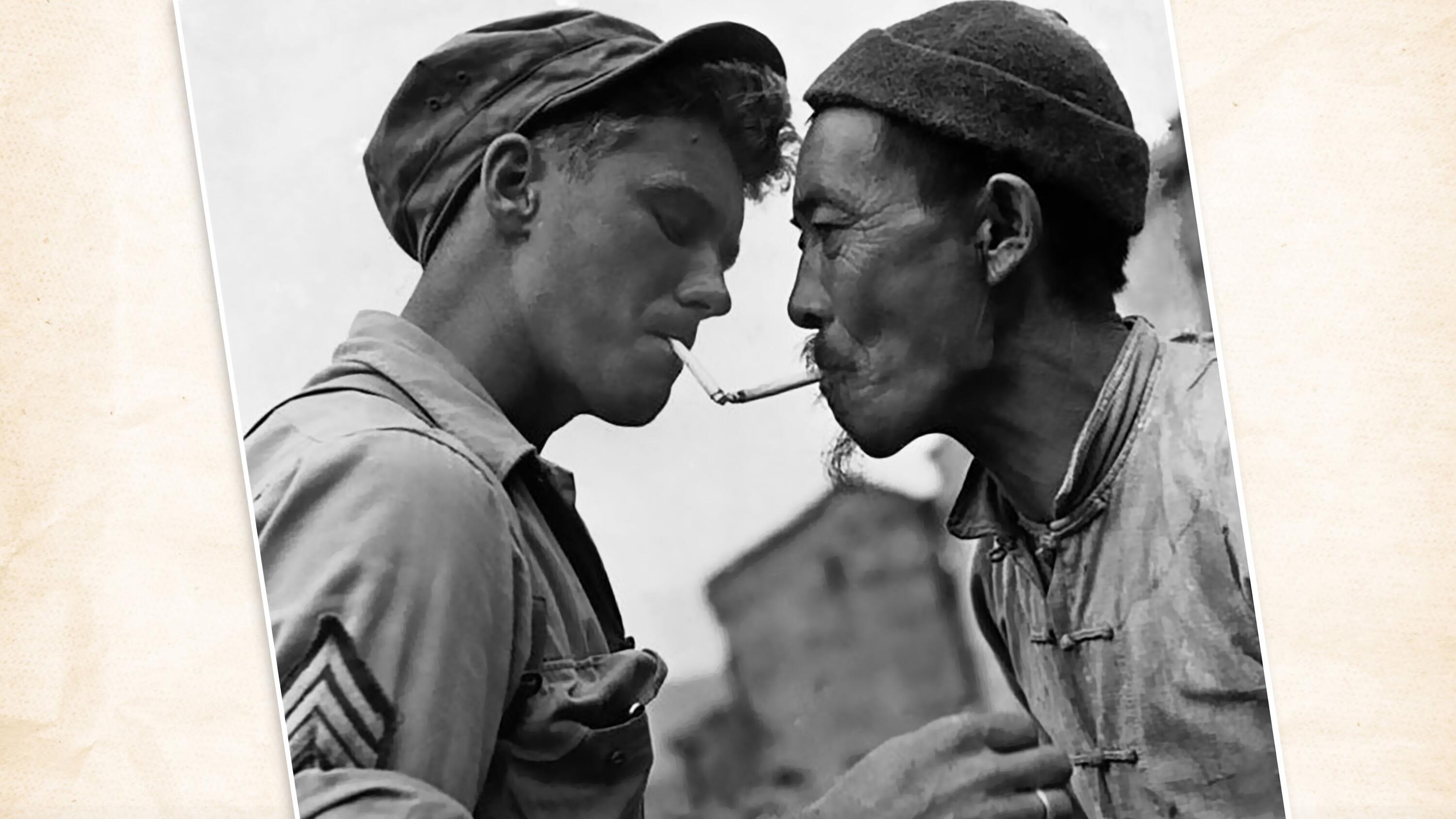 Pausing on a street in Tengchong, China, a Chinese civilian obtains a light from a U.S. Army sergeant during the liberation of the city from the Japanese military. 1944. (U.S. National Archives)