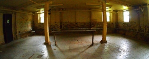 large empty basement room with two small windows