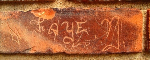 the name Faye N. carved in brick in wall