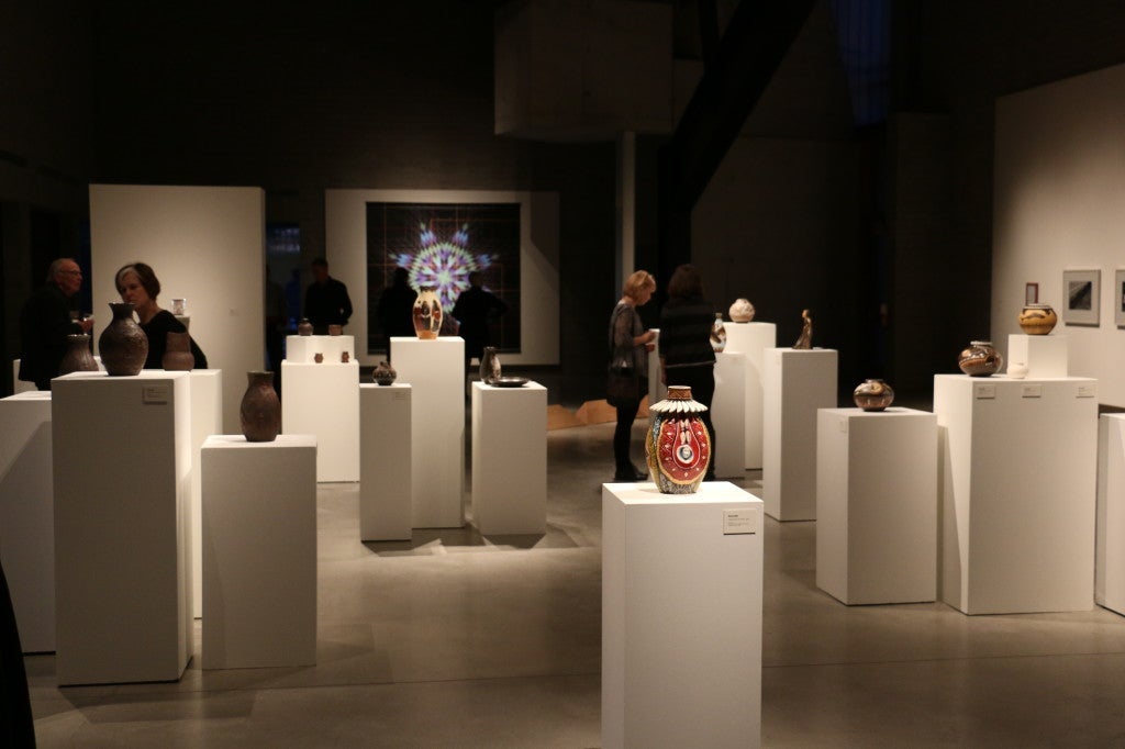 gallery with people looking at artworks