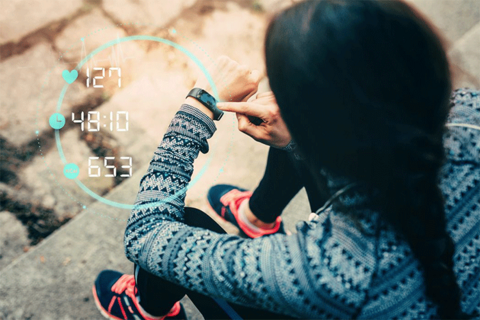 A girl looking at a fitness tracker