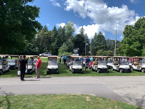 golfers on their golf carts at the 2024 golf tournament 