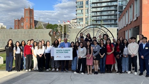 A group photograph featuring many diverse youth surrounding the mayor of the City of Kitchener commemorating their participation in the Kitchener Youth Climate Action Fund