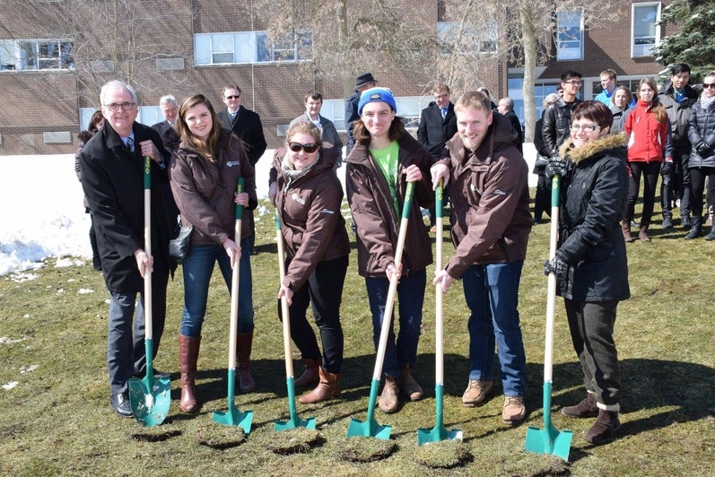 staff and students making first dig at new building