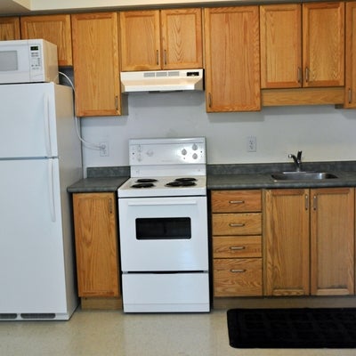 A photo of a typical kitchen, with fridge, stove and sink