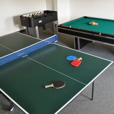 Ping pong table, with pool table behind it
