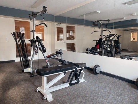 fitness room with exercise bench and Bowflex