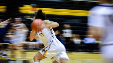 motion blurred image of girl playing basketball