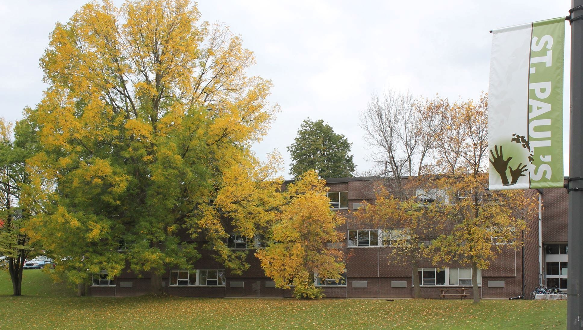 Exterior shot of St. Paul's with golden leaves on the trees and ground