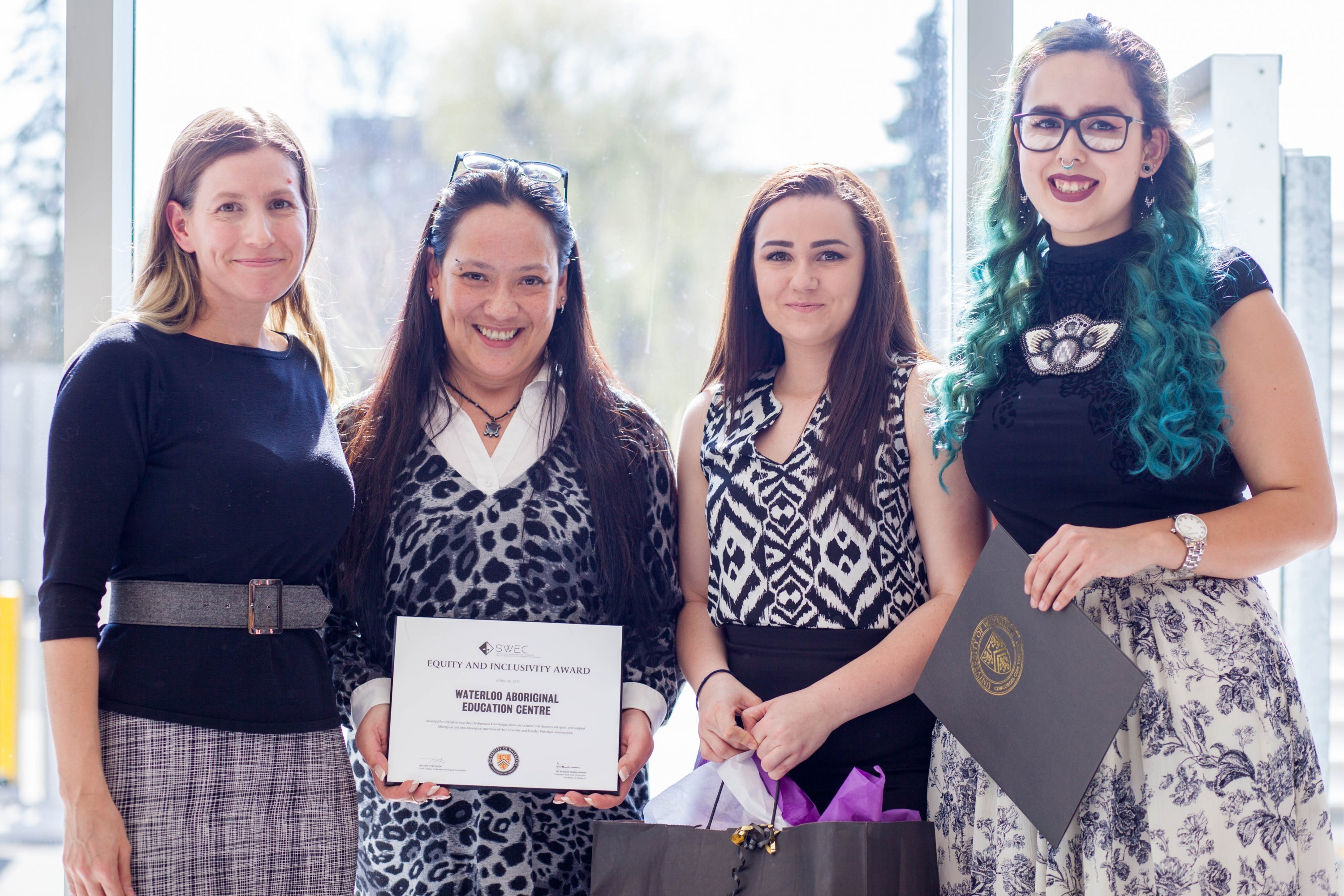 Group of 4 women, 3 are Indigenous students accepting the award