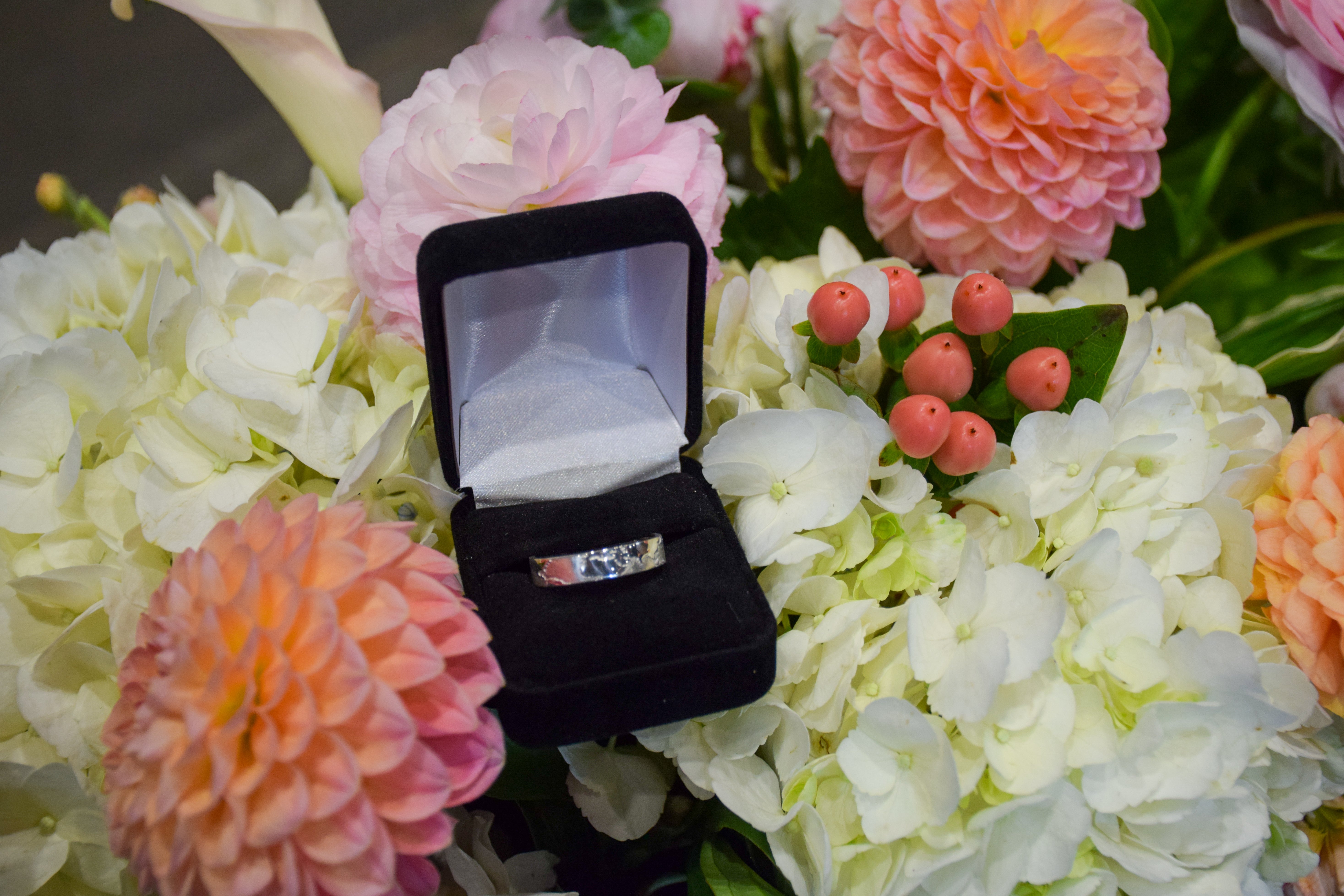 Class Ring for 2024 INDEV graduating class sitting in flowers 