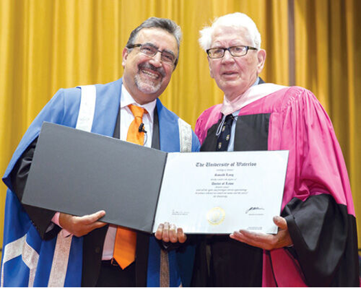 Pictured left, Feridun Hamdullahpur, the University of Waterloo's sixth president and vice-chancellor (2010-2021) beside Dr. Ronald William Lang receiving and accepting an honorary Doctor of Laws (LLD) degree from the University of Waterloo in 2014 for his major contributions to protecting workers’ rights and developing public policy (Carter, 2015). 