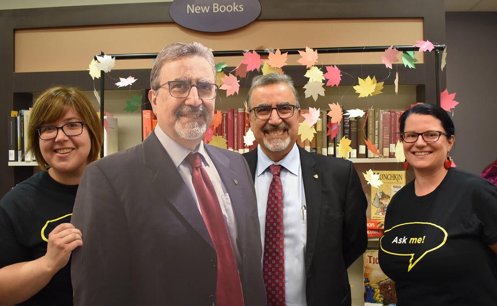 Feridun Hamdullahpur stands next to a full-sized cardboard cut out of himself