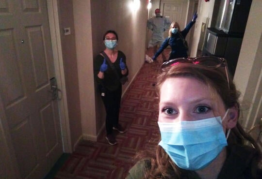 The team at Houe of Friendship ose in masks, 2 meters apart, in the hallway of one of their housing locations.