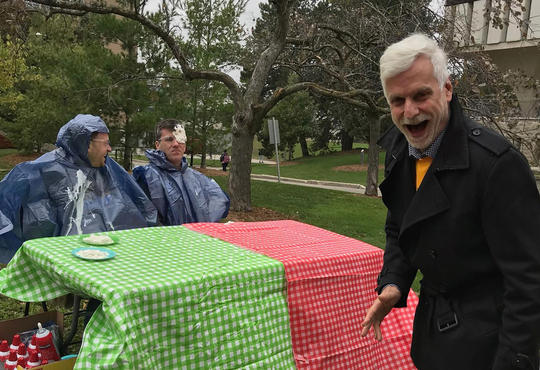 Associate Dean Bill Chesney hit fellow staff member in the face with a cream pie as part of a fundraiser