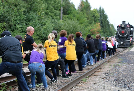 Waterloo Warriors team pulling an old fashioned train