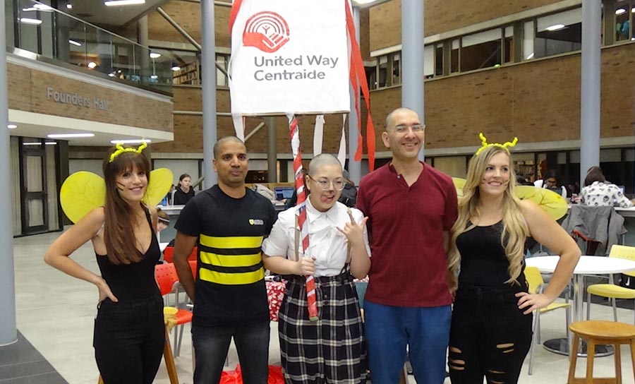  Prath Balasingam, Mona Zhu, and  Ori Friedman with their newly bald heads, and their hairdressers dresses as bumble bees for Halloween