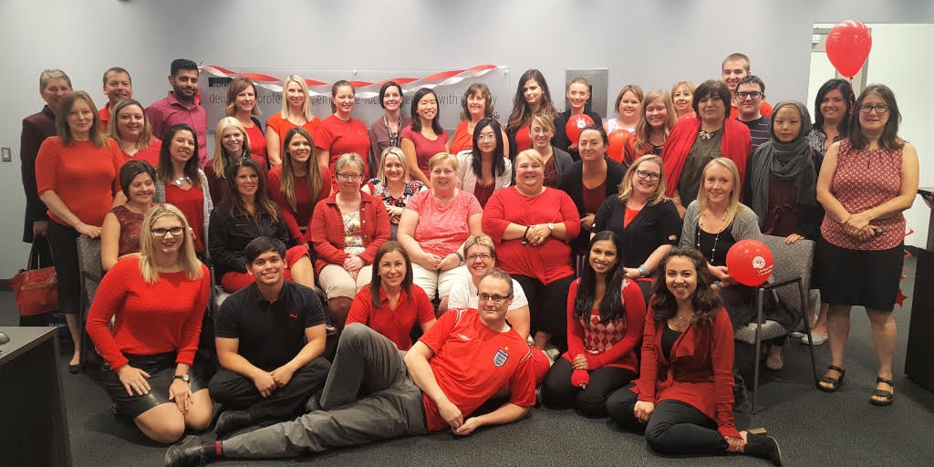 Members of Human Resources dressed up in red