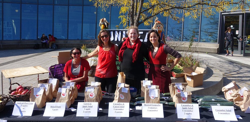 A group of volunteers sells bagged lunches to raise money
