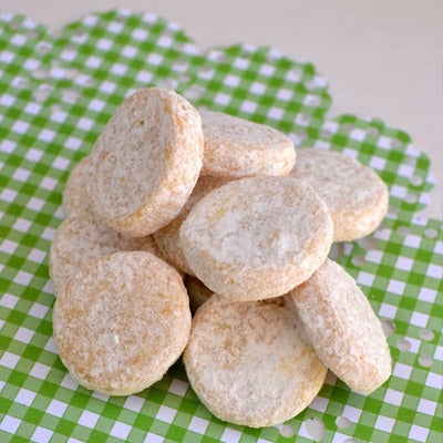A pile of shortbread cookies dusted in icing sugar