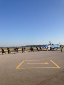 UW volunteers pull plane for United Way