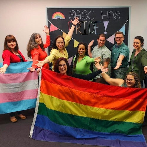 Sexual Assault Support Centre staff with the Pride flag.