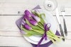 Purple tulips across dinner plate