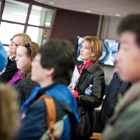 a group of people watching a presentation