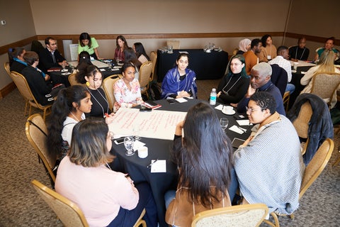 people sitting around a table in discussion