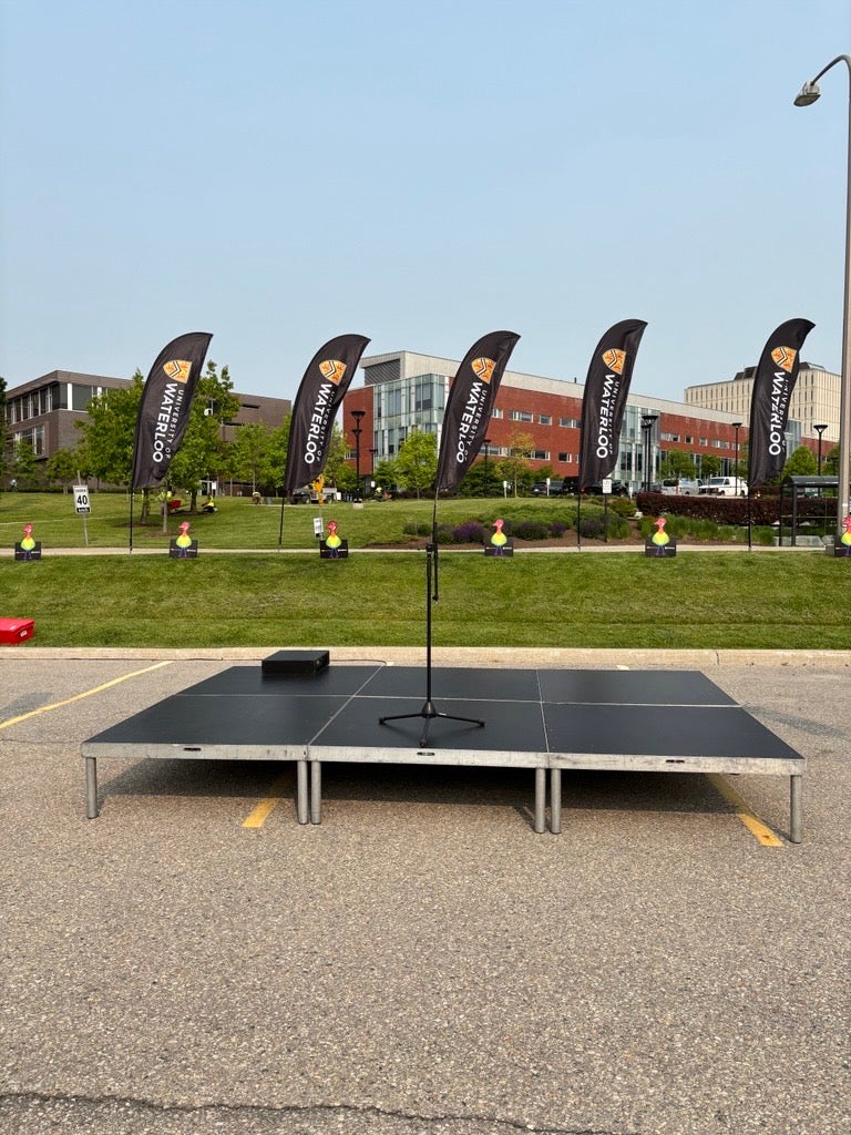 Black feather-style banners displaying the “University of Waterloo” name and crest logo.