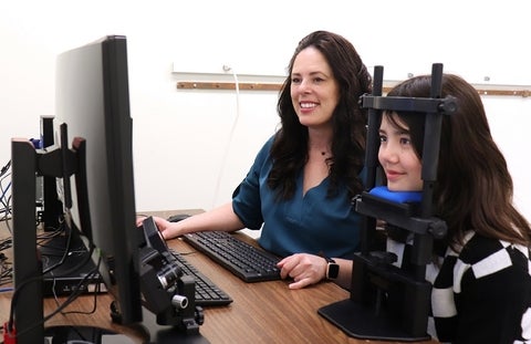 Dr. Krista Kelly works tests the vision of a young patient