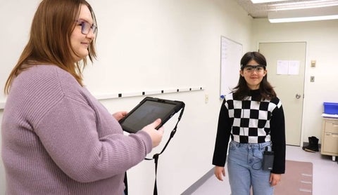 Lauren Hoare works with a young patient in the lab