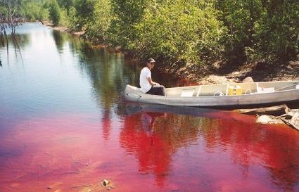 Person in a canoe at an acid mine lake