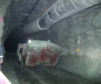 Machine piled high with ore, at work in the mine