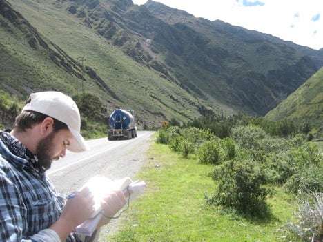 Student writing notes on landslide hazard and risk on Antamina Mine access road.