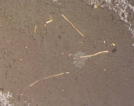 Microscopic view of Narumi gold ore with native gold and chlorite in quartz