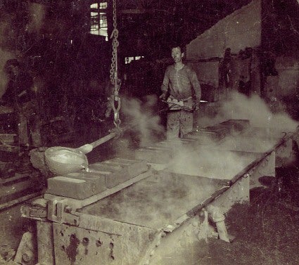 Pouring molten copper into ingot molds