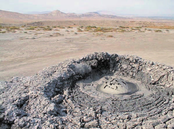 A small methane bubble breaks the surface of a mud volcano in Baku
