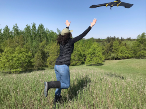 Person letting a drone into the air